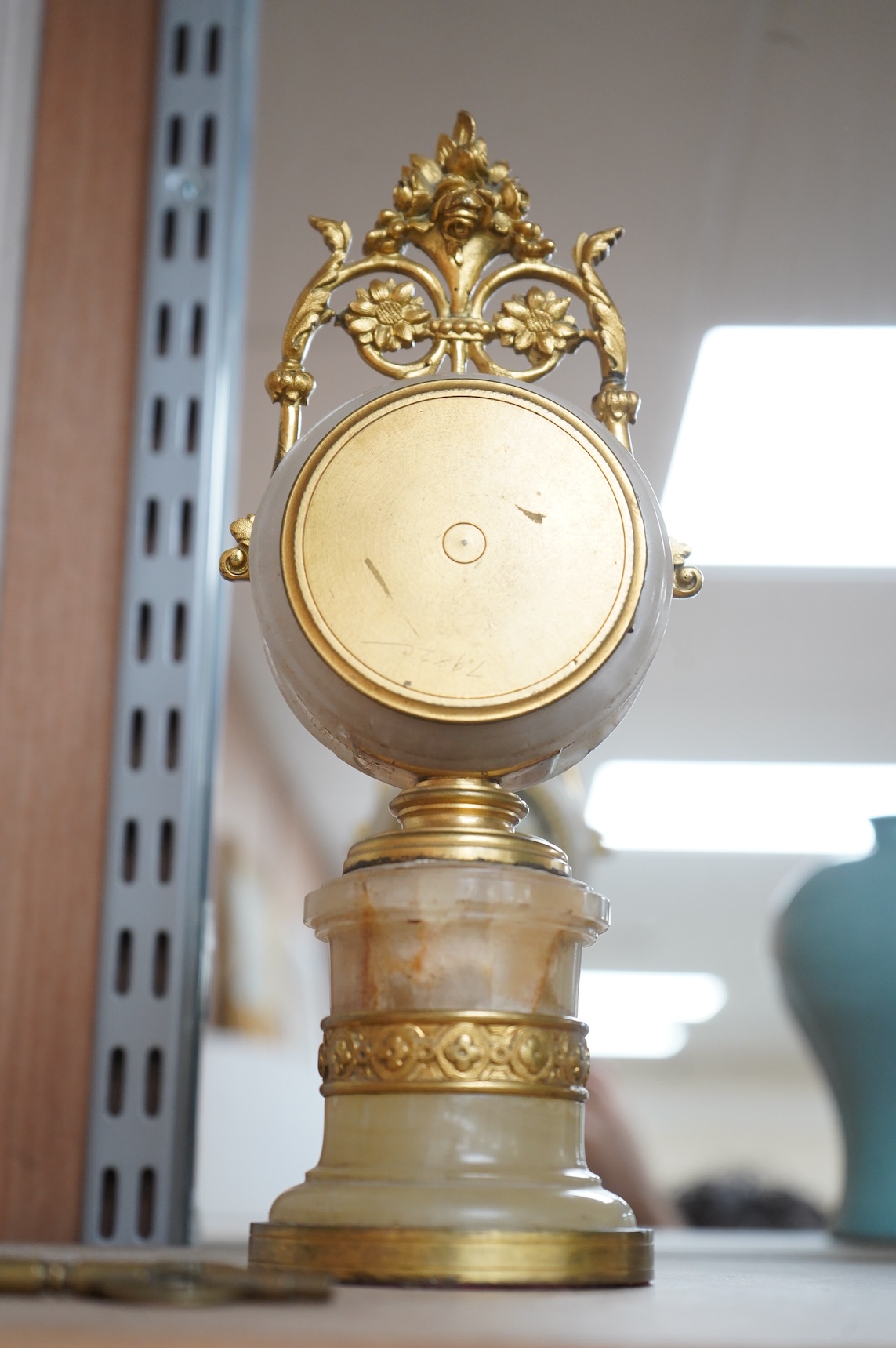 A late 19th century French ormolu and alabaster timepiece with painted dial and key, 24cm high